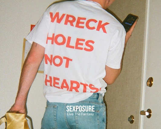 Model wearing a 'Wreck Holes Not Hearts' t-shirt from SEXPOSURE's inclusive apparel line.