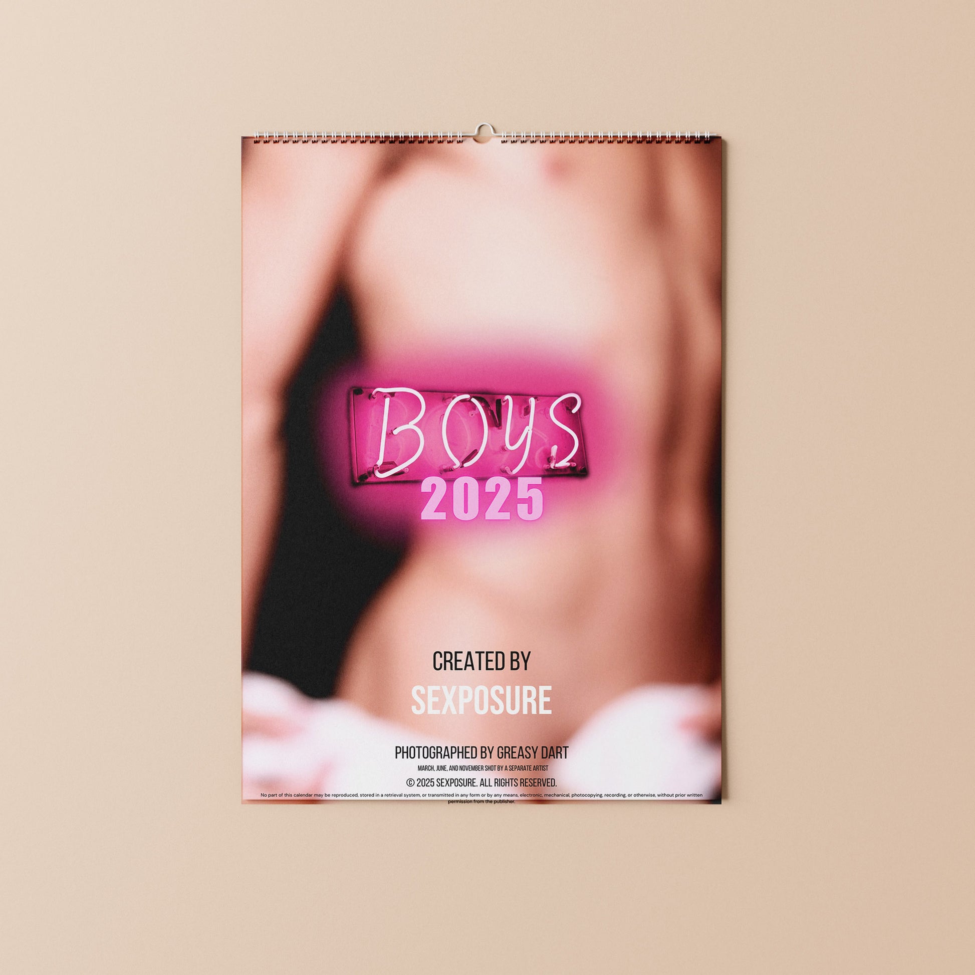 Back of the calendar featuring boys 2025, a blurred picture of a torso. and credits to the photographer.